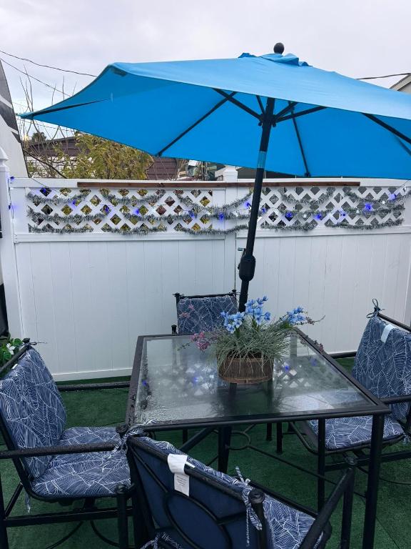a table with a blue umbrella on a patio at Paradise RV in Tampa