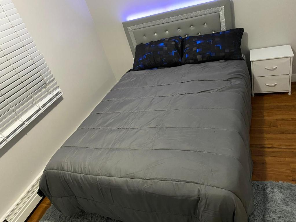 a bed in a small bedroom with a window at Bold property in Calgary
