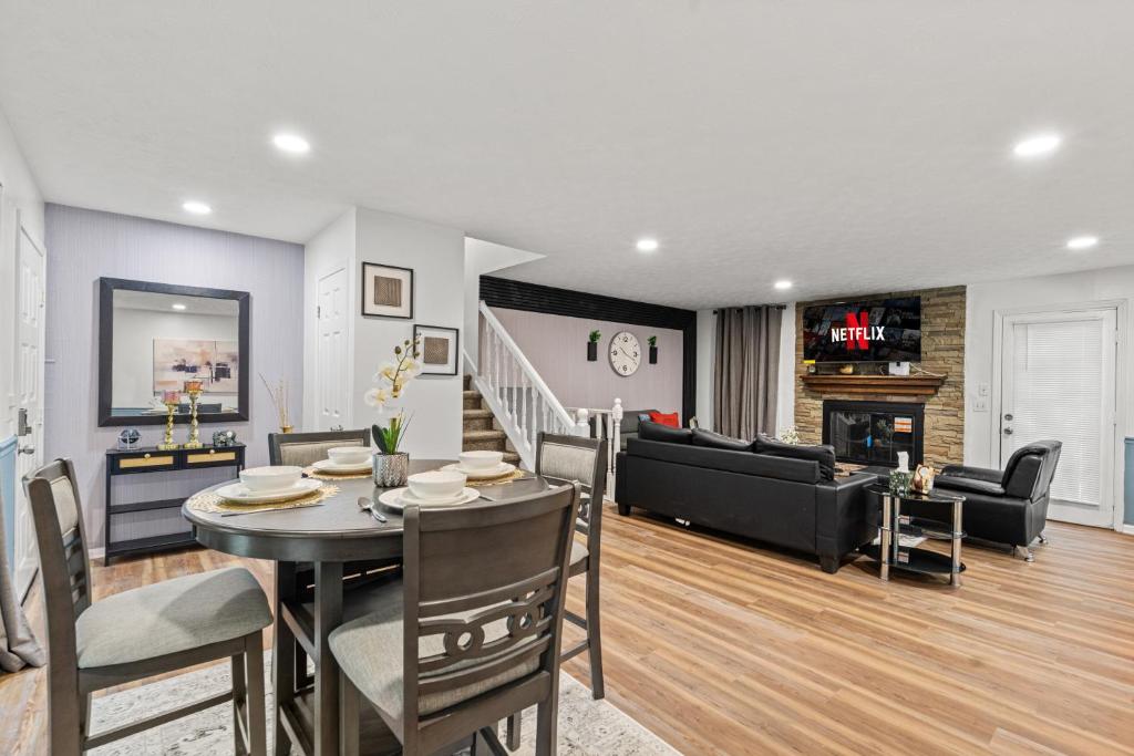 a dining room and living room with a table and a couch at Relaxation spot lawrenceville in Lawrenceville