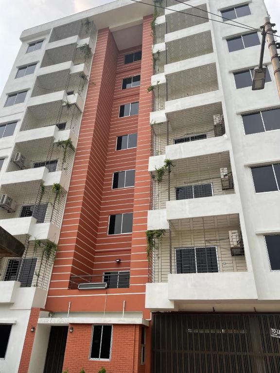 a tall apartment building withenced in balconies at Best Eastern Suite in Dhaka