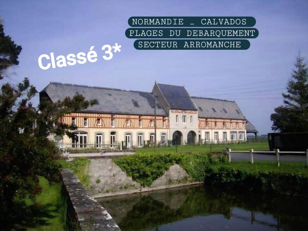 a large building with a pond in front of it at Chez Les Ch'Tis in Commes