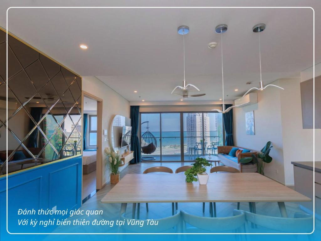 a kitchen and living room with a dining room table at The Song - Vitamin Sea & Sun - Căn Hộ Cao Cấp và Sự Lựa Chọn Tốt Nhất in Vung Tau