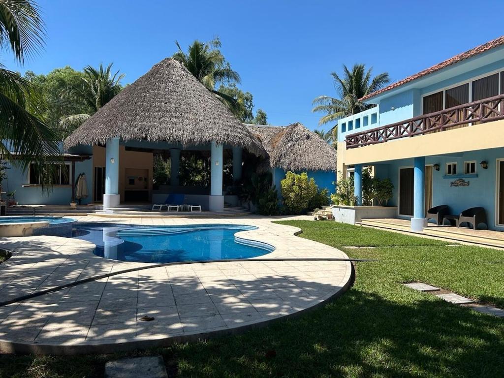 a villa with a swimming pool and a resort at Casa Puerto in El Garitón