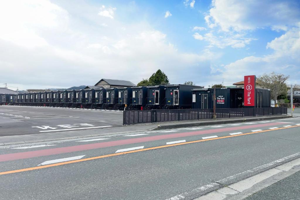 an empty street with a row of portable toilets at HOTEL R9 The Yard Yamaga in Kumamoto