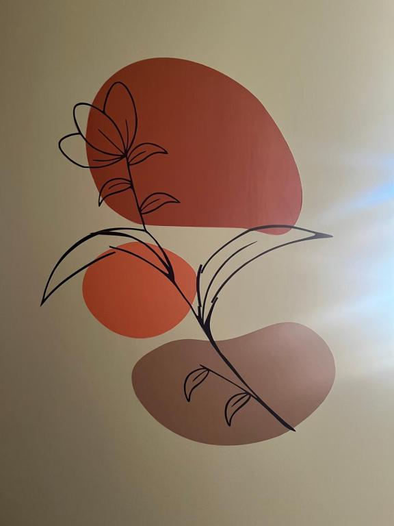 a drawing of a plant with red leaves at Conforto e simplicidade no centro da cidade in Santana do Livramento