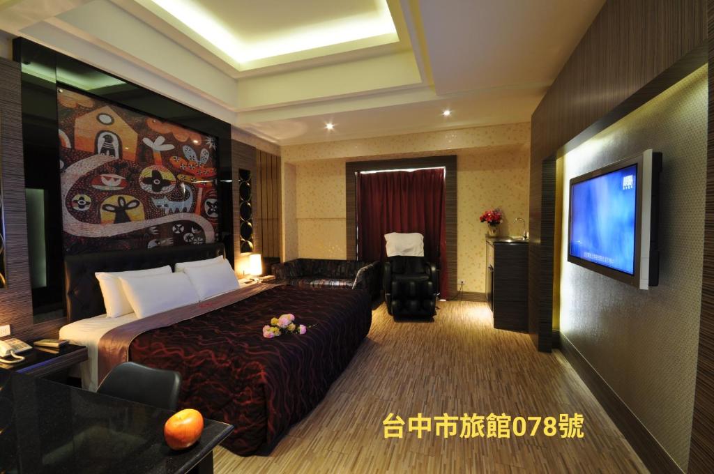 a hotel room with a bed and a flat screen tv at 采岩汽車旅館 in Taichung