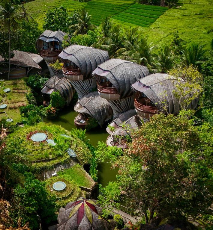 an aerial view of a group of houses in a river at Ulaman Eco Luxury Resort in Tabanan