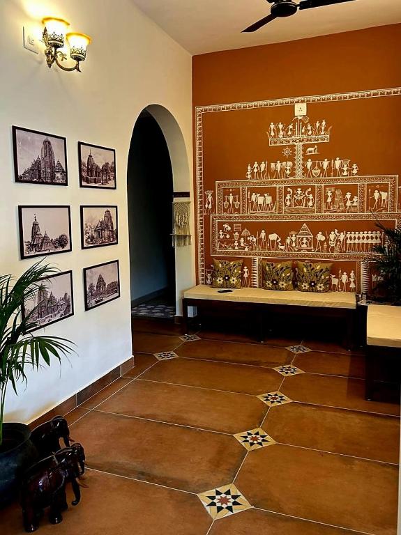 a room with a table and a chandelier on the wall at Parijat Heritage in Bhubaneshwar
