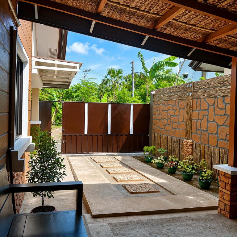 a patio with potted plants and a fence at Block 23 - Dogwood in Bacolod