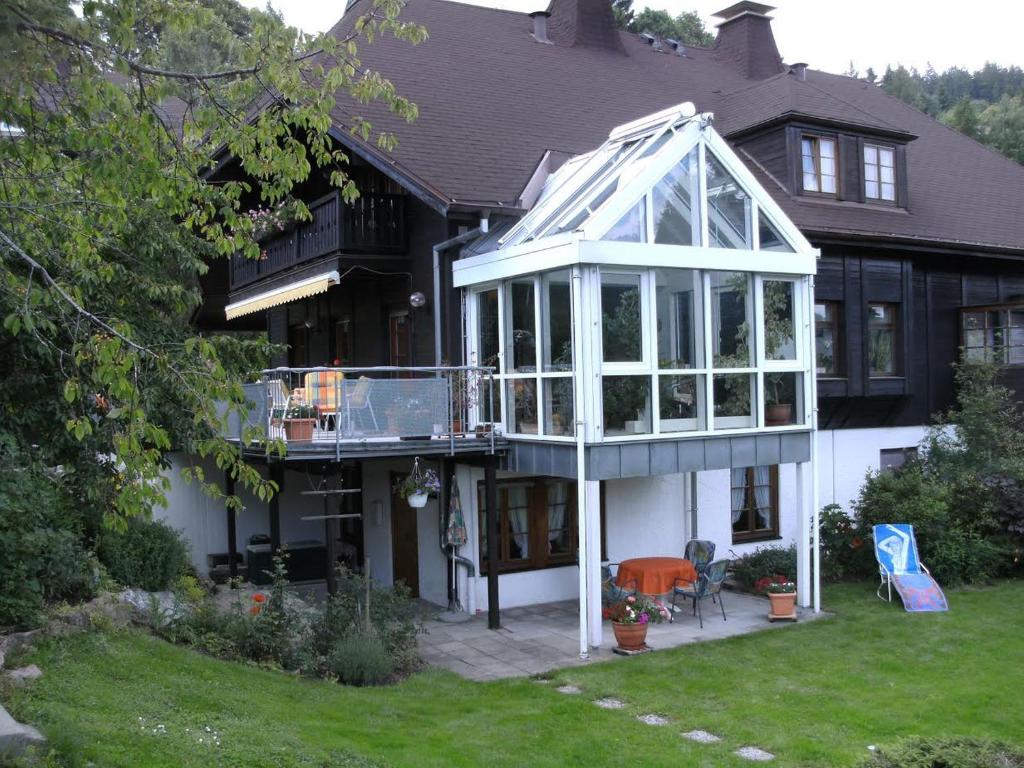 a house with a conservatory on the front of it at Haus Aretz in Feldberg