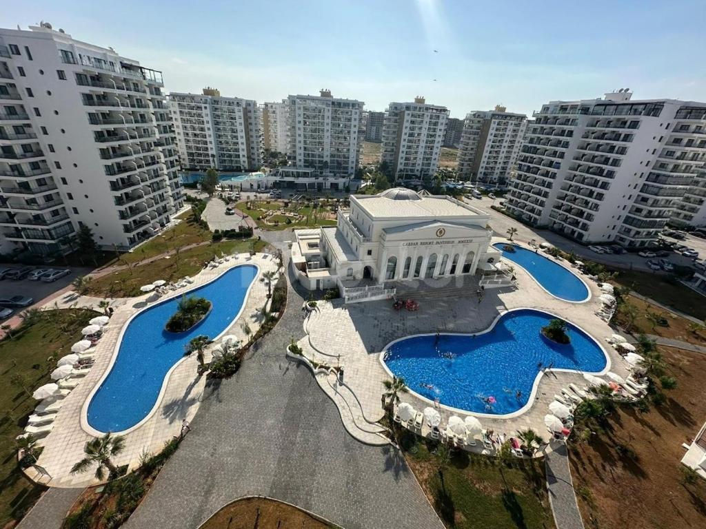 an aerial view of a city with two swimming pools at Caesar resort 2 bedrooms Cornelius in Vrysoules