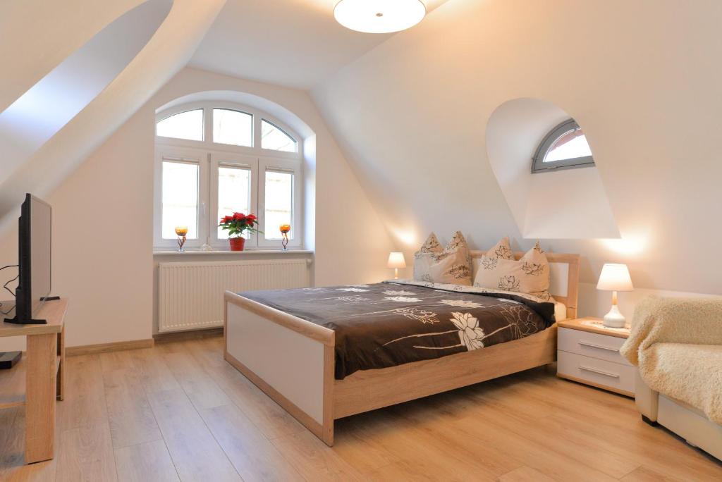 a bedroom with a bed and an attic at Willa Muszelka - Apartamenty in Świnoujście