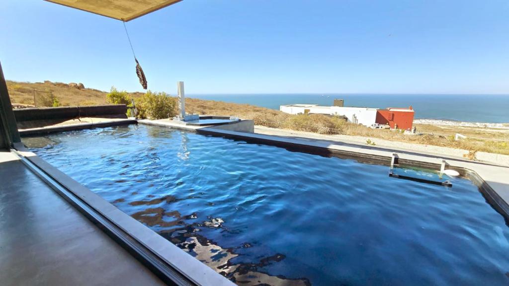 a swimming pool with the ocean in the background at Walvishaai in Stompneusbaai