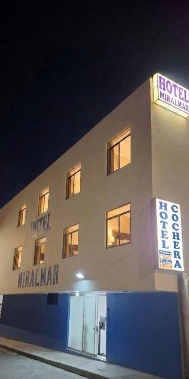a hotel with a sign on the side of a building at Hotel MIRALMAR in El Puente
