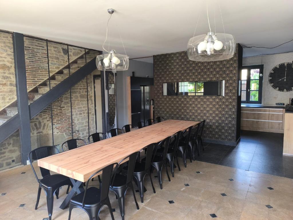 a large dining room with a wooden table and chairs at Chez Marine & Justine in Charolles