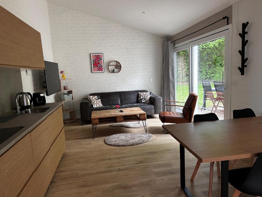 a living room with a couch and a table at Cosy 26 - Zuid-Limburg in Simpelveld
