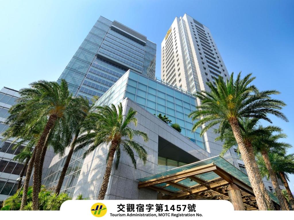 a group of palm trees in front of a building at Windsor Hotel Taichung in Taichung