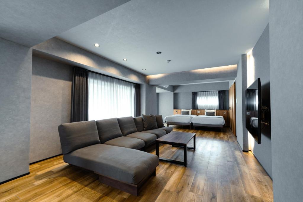 a living room with a couch and a bed at ulu Tokyo in Tokyo