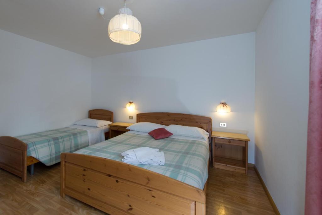 Łóżko lub łóżka w pokoju w obiekcie Residence Villa Boschetto