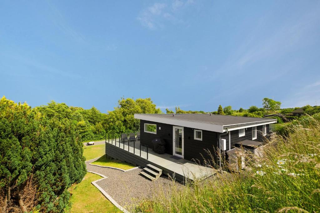 a black house with a black roof at Modern Holiday Home On Adventurous Bornholm in Allinge