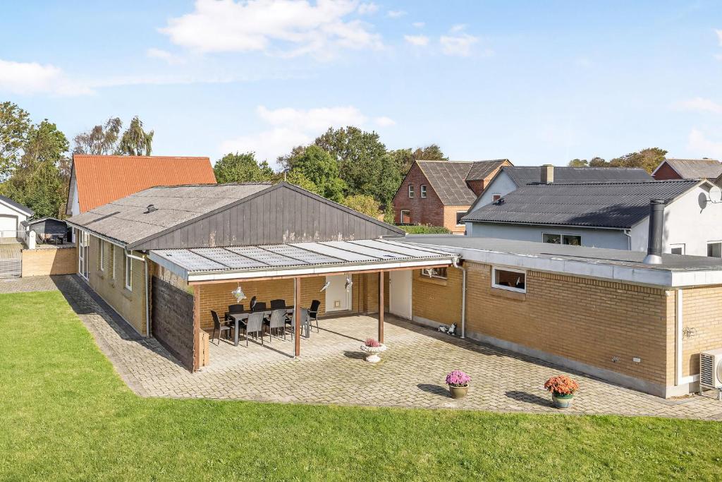 a large brick building with a patio in a yard at Cozy And Spacious Townhouse In Aars in Års