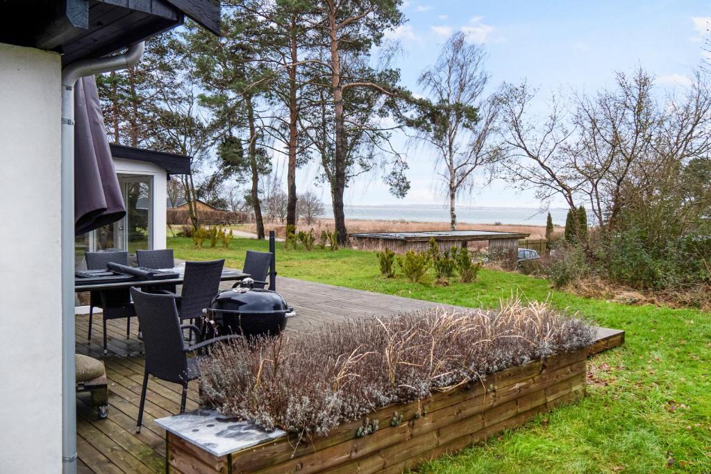 a backyard with a grill and a table and chairs at Amazing Holiday Home With View At The Water in Vig