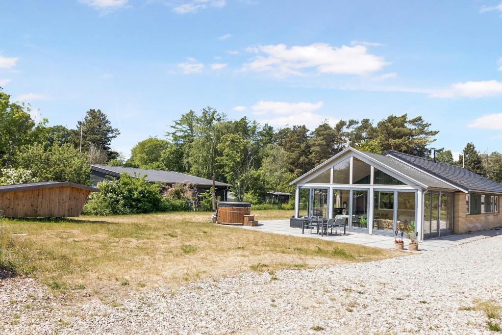 a house with a pitched roof at Holiday Home With Outdoor Jacuzzi And Shelter in Vig