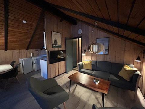 a living room with a couch and a table at Mtb Beach Peace Holiday By The Dunes in Fjerritslev