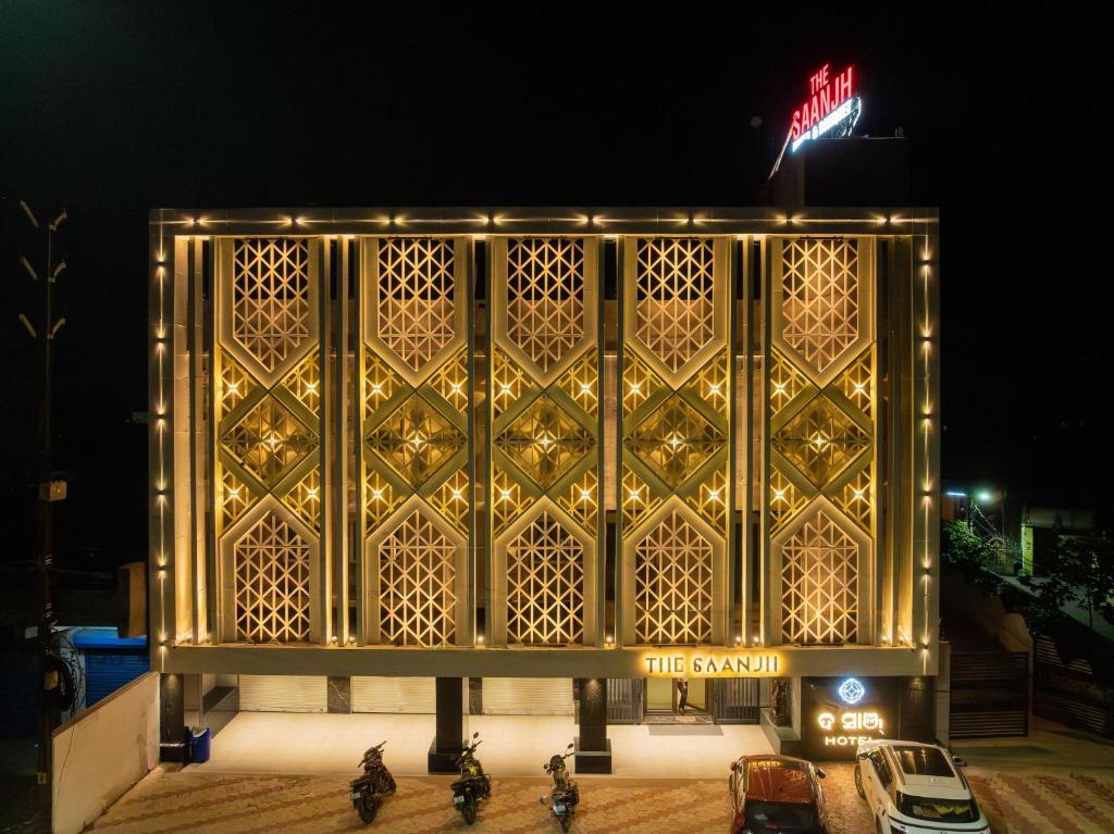 a golden facade of a building at night at The Saanjh Hotel in Angul