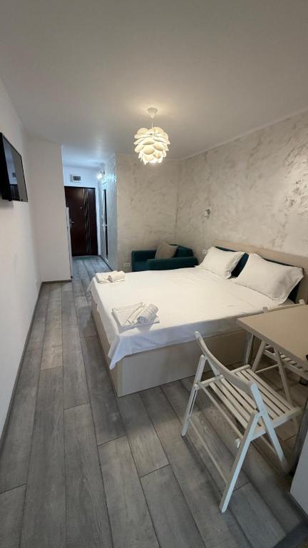 a bedroom with a large white bed and a couch at SAB Luxury Apartaments 2 Saturn in Saturn