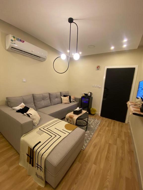 a living room with a bed and a couch at شقة هادئة مودرن in Al Khobar