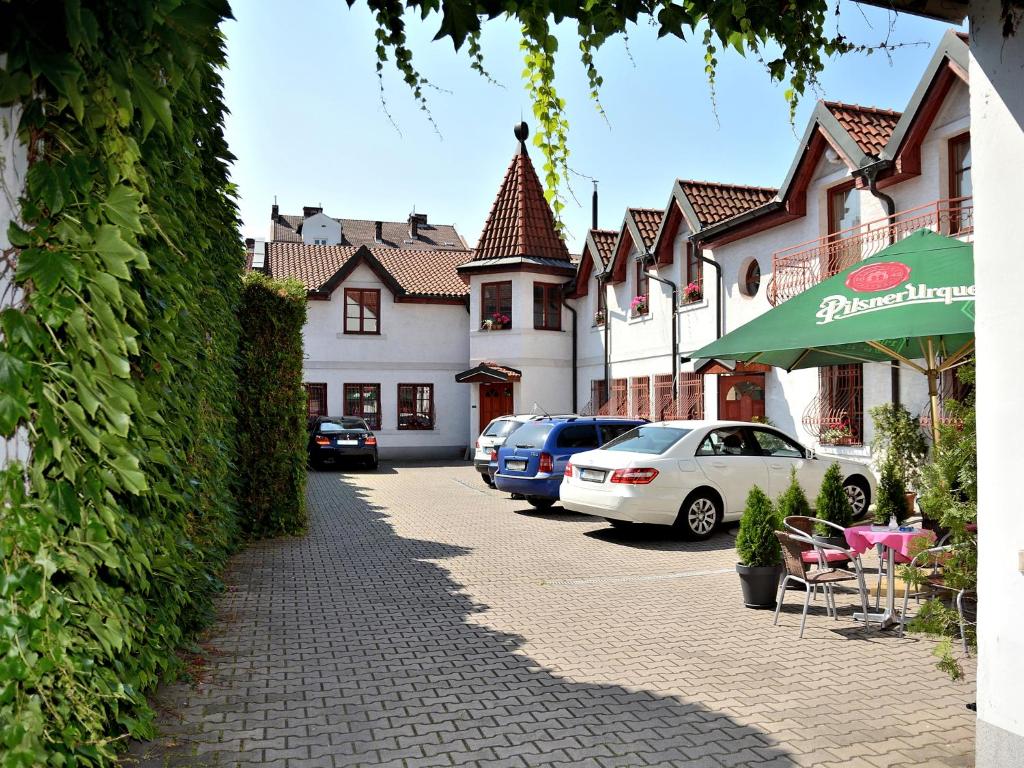 a street with cars parked in front of a building at Hotel Atrium in Pardubice