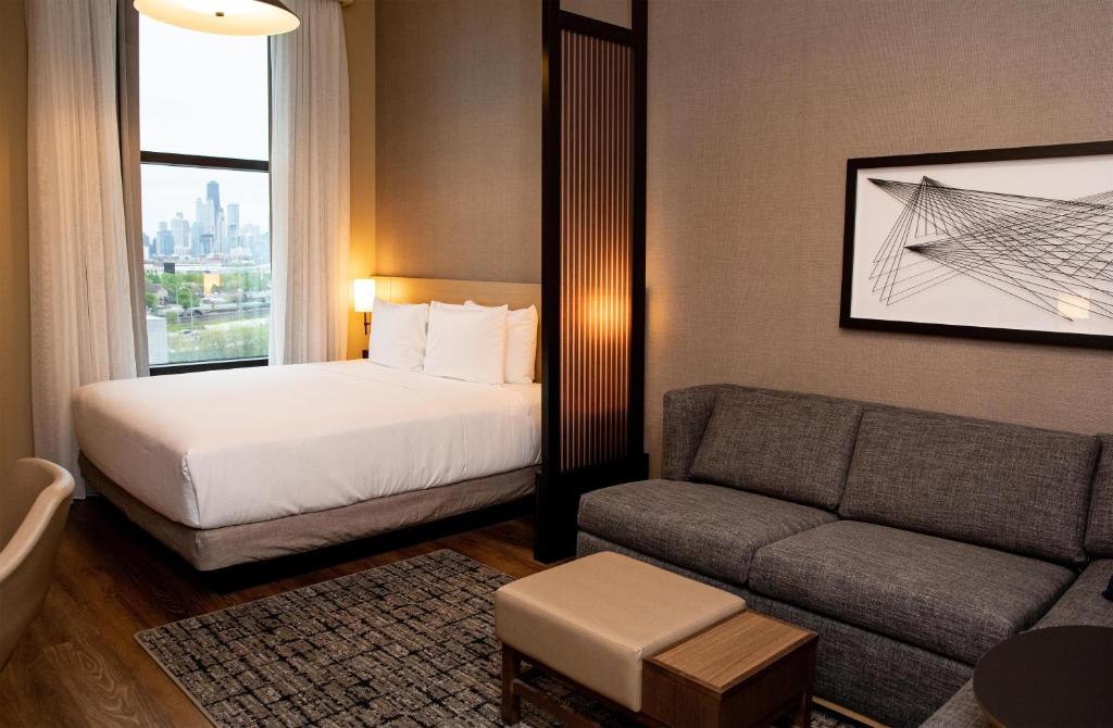 a hotel room with a bed and a couch at Hyatt Place Chicago Wicker Park in Chicago