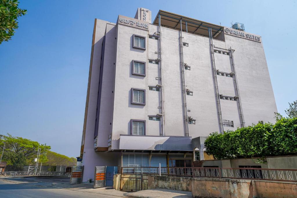 a tall white building on the side of a street at Open Hotel by Olive - Urban Suites in Bangalore