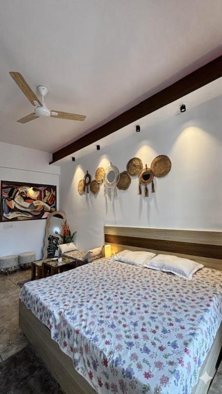 a bedroom with a bed and a ceiling fan at Golden Nest Stays in Ghaziabad