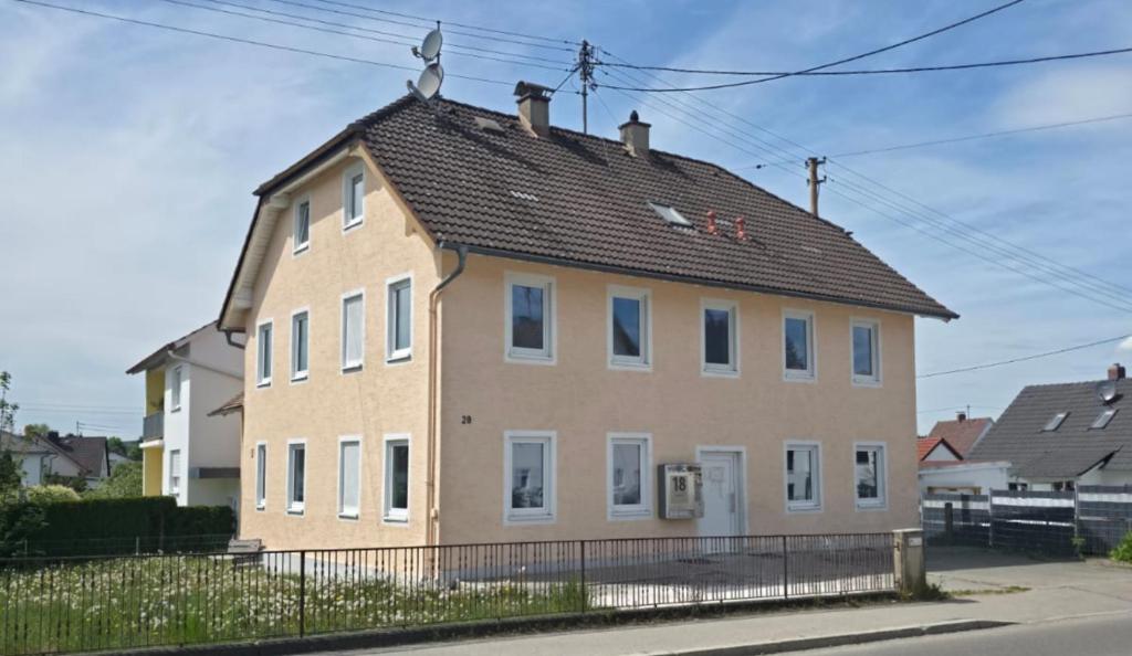 a large brown house with a black roof at My Pension City Großaitingen - Augsburg in Großaitingen