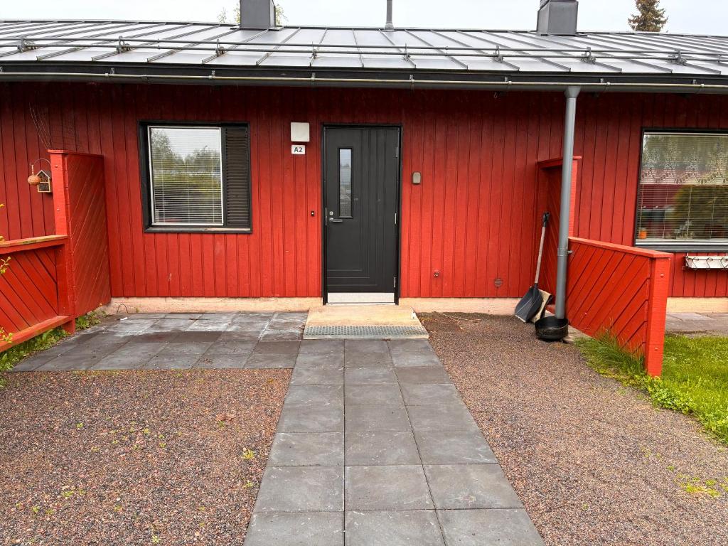 a red building with a black door and a black door at Koivukuja in Köyliö
