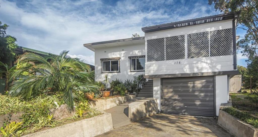 a white house with a garage at Iconic Escape Nowra in Nowra