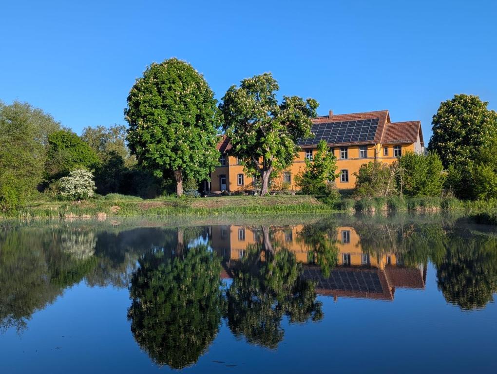 a house with its reflection in a lake at Pirol in Niederfinow