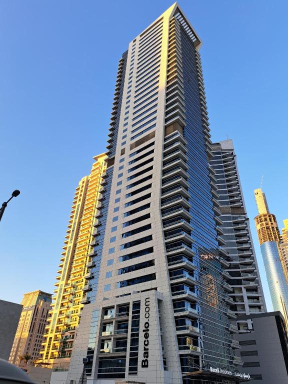 a tall building with many windows in a city at Barceló Residences Dubai Marina in Dubai