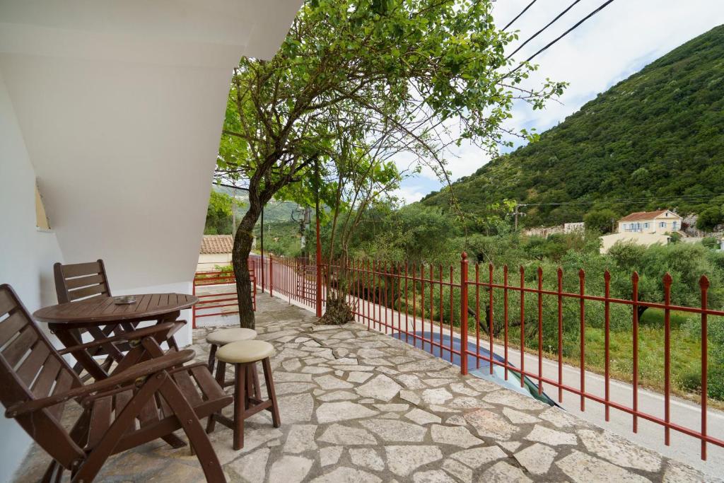 a patio with two chairs and a table and a fence at Studio Liana in Frikes