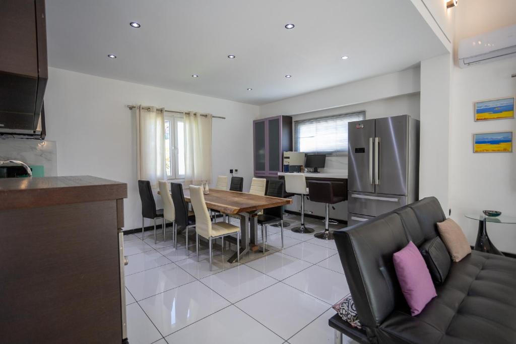 a kitchen and dining room with a table and chairs at Mario's Kassiopi in Kassiopi