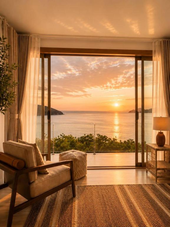 a living room with a view of the ocean at Reen Run Sunset Private Pool Villa in Ko Phangan