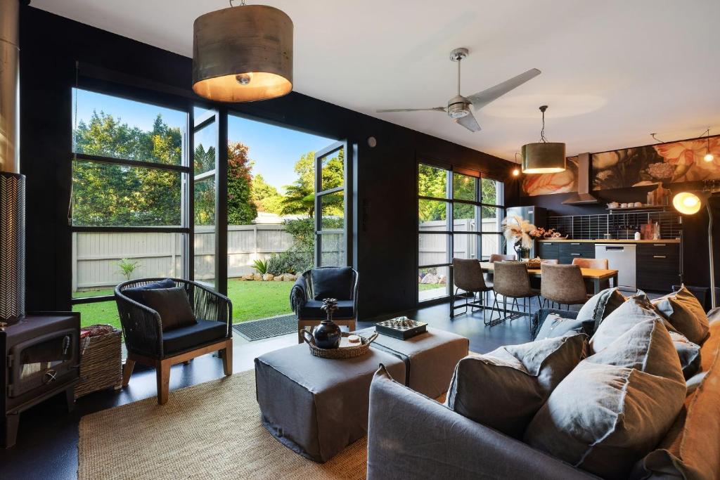 a living room with a couch and a table at Glenbrook Guest House in Ewingsdale