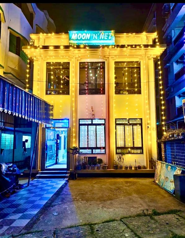 a building with a sign on the front of it at Hotel Moon N' Net in Digha