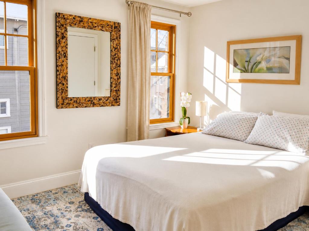 a bedroom with a bed and a mirror on the wall at Elegant Cambridge Room, Short Walk to Harvard in Cambridge