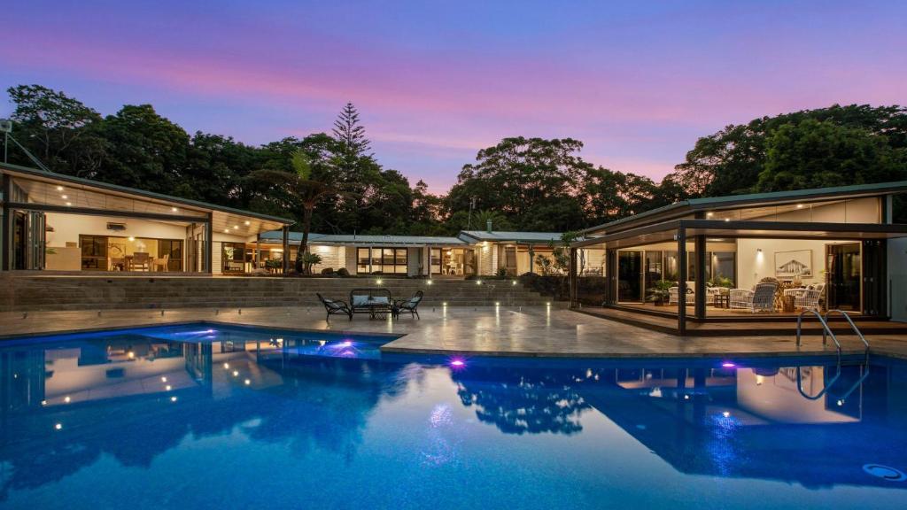 an exterior view of a house with a swimming pool at Glenbrook House and Studio in Ewingsdale