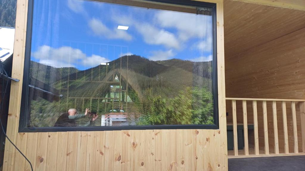 a large window with a view of a mountain at Eco Cottage Rose in Borjomi