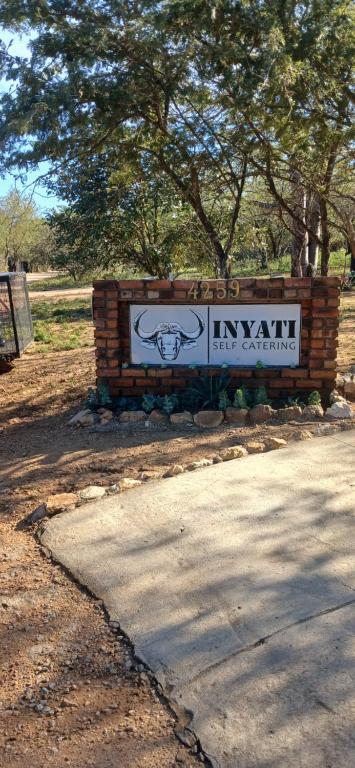 a sign for an event in an amusement park at Inyati Guest House in Marloth Park