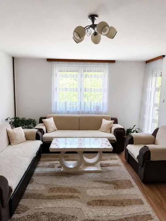 a living room with a couch and a coffee table at Apartman Sofija - Foča in Foča